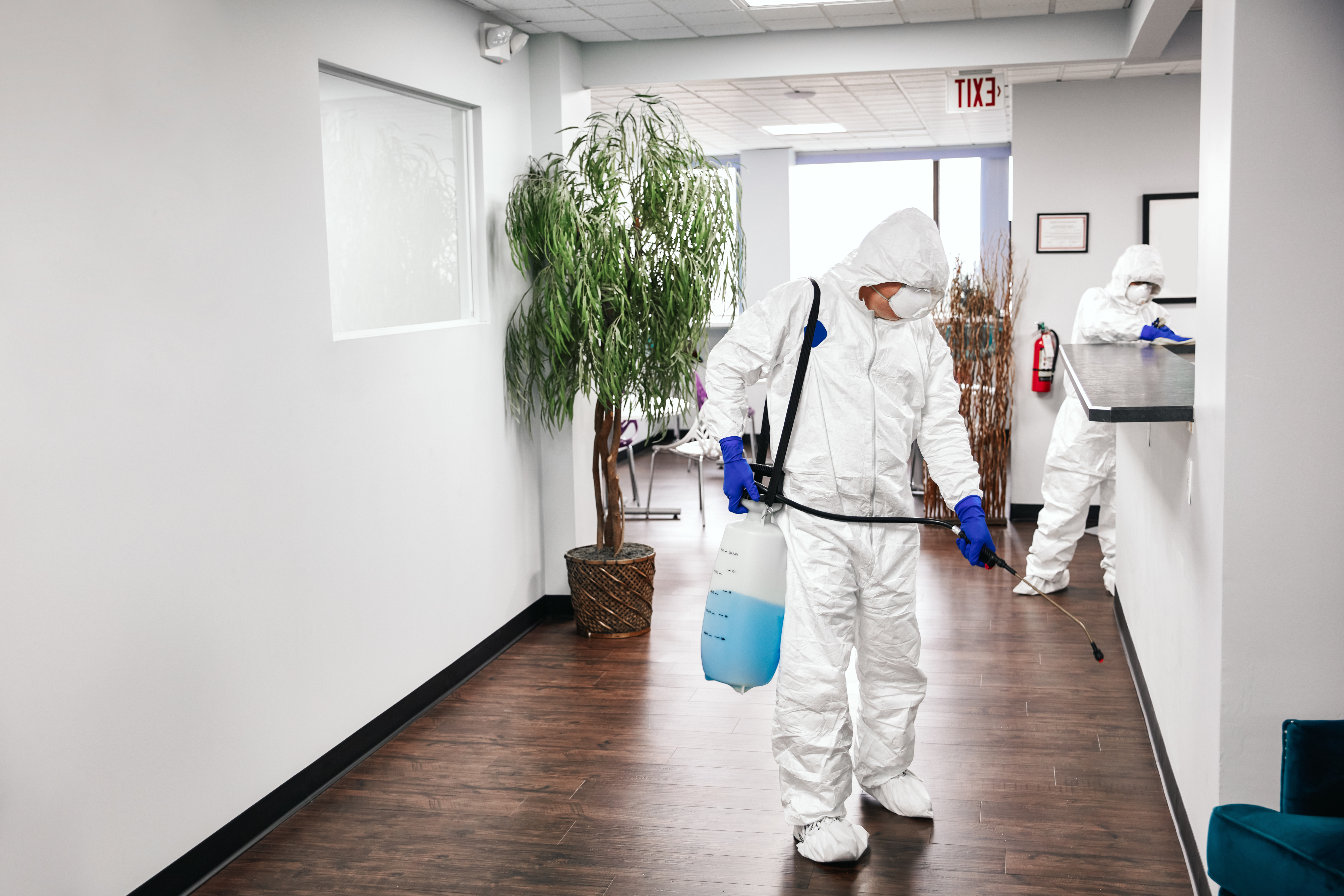 Man Disinfecting halllway